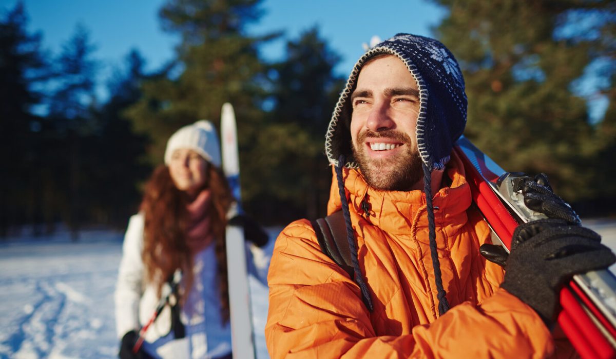 Happy and healthy skiers spending vacation at winter resort